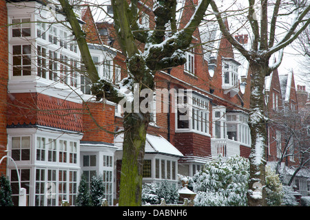 Snow falling in front of Arts and Crafts style houses in Bedford Park, London, England, United Kingdom, Europe Stock Photo