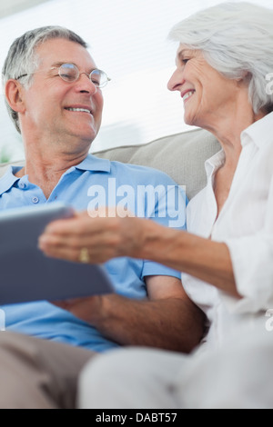 Cheerful mature couple using a digital tablet Stock Photo