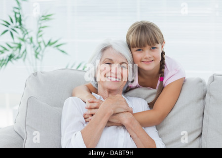 Little girl hugging her grandmother Stock Photo