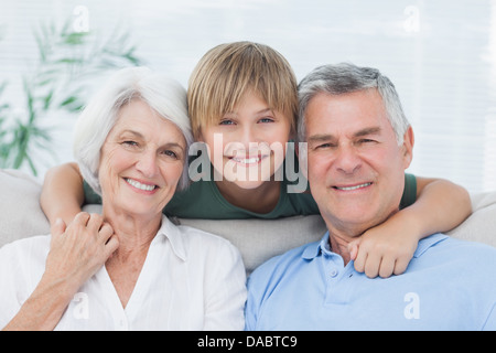Grandson embracing his grandparents Stock Photo