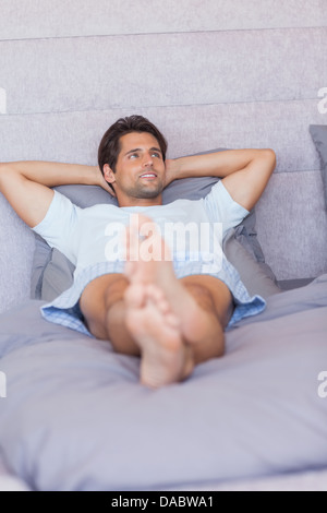 Man relaxing in his bed Stock Photo