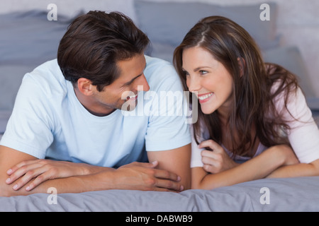 Man and woman lying on bed