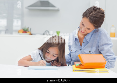 Mother looking at her daughter drawing Stock Photo