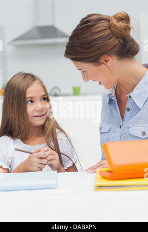 Mother chatting with her daughter drawing Stock Photo