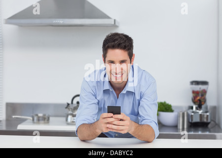 Man typing on his smartphone Stock Photo