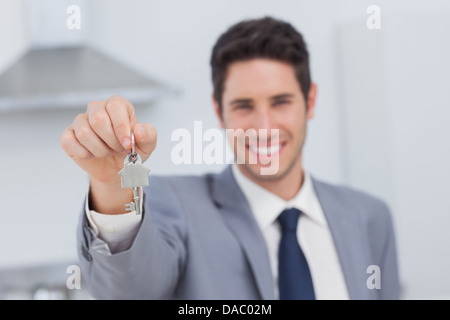 Real estate agent presenting house key Stock Photo