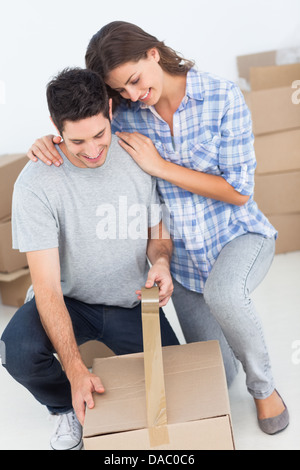 Woman and man wrapping a box Stock Photo