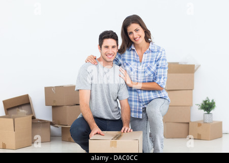 Portrait of a woman and her husband wrapping a box Stock Photo