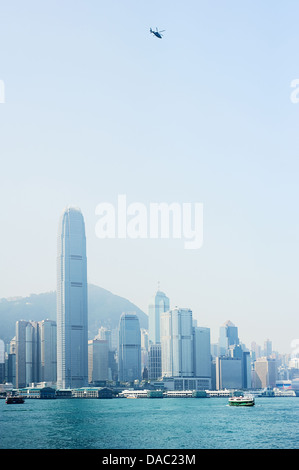 Helicopter in Hong Kong sky at sunset Stock Photo