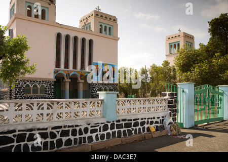 Africa, Eritrea, Massawa, Tualud, beggar in shade outside St Mary’s catholic Cathedral Church Stock Photo