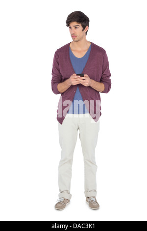 Thoughtful man using his mobile phone Stock Photo
