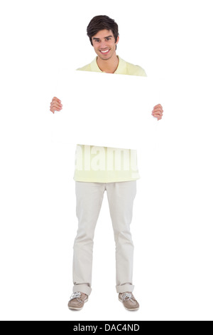 Smiling man holding empty sign Stock Photo