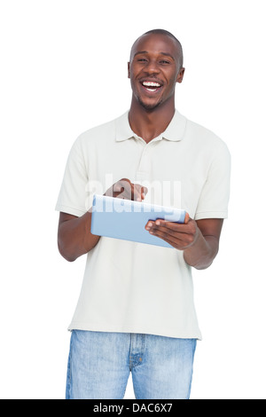 Laughing man using tablet pc Stock Photo