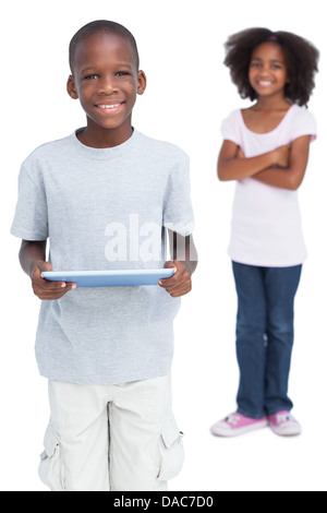 Boy using tablet pc with his sister Stock Photo