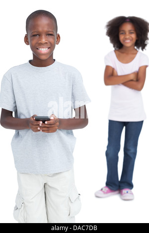 Smiling boy using mobile phone Stock Photo