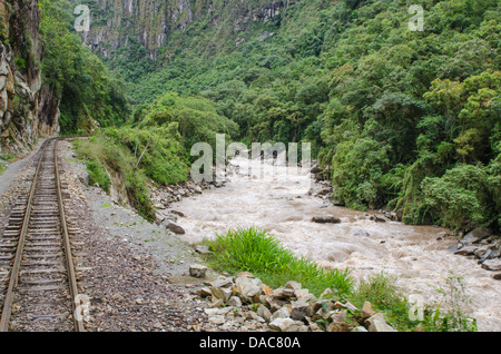 Rail line train tracks railroad alongside Vilcanota River Sacred Valley near Aguas Calientes, Peru. Stock Photo