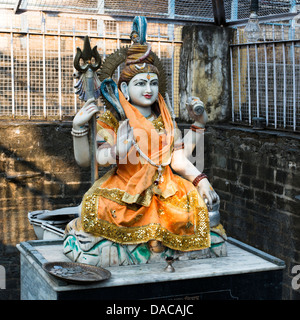 The Hindu God Shiva sits opposite a temple in Chamba, Himachal Pradesh, India Stock Photo