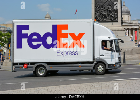 FedEx Express white delivery lorry truck side view of business logo branding and driver in Trafalgar Square  London England UK Stock Photo