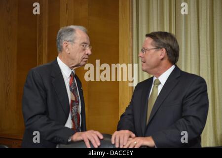 Washington, DC, USA. 10th July, 2013. Sen. CHUCK GRASSLEY, D-IA, left, speaks with LARRY POPE, president and CEO of pork producer Smithfield Foods, Inc. before a heairng of the U.S. Senate Agriculture Committee on the proposed takeover of Smithfield by Shuanghui International, a Chinese company. © Jay Mallin/ZUMAPRESS.com/Alamy Live News Stock Photo