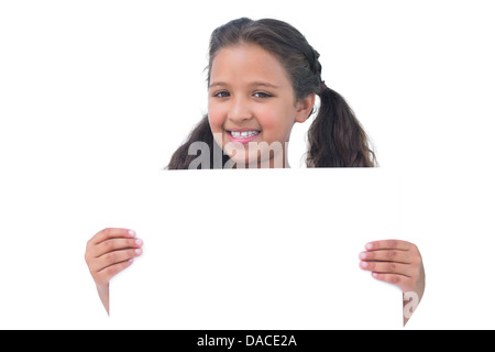 Smiling little girl holding and presenting sign at camera Stock Photo