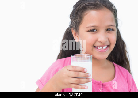 Smiling little girl drinking milk Stock Photo