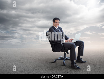 Handsome businessman sitting on a swivel chair Stock Photo