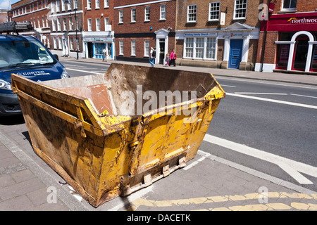 Builders skip on street ready to be filled with waste. Reading, Berkshire, England, GB, UK Stock Photo