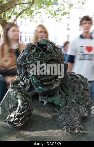 The bronze and granite sculpture “Conversation with Oscar Wilde” made by Maggi Hambling. People are rushing past to Charing Cross Station. London, UK. Stock Photo