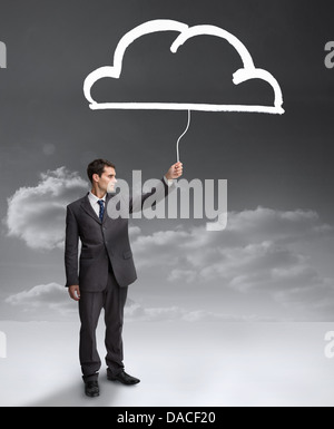 Businessman holding a drawing of a cloud Stock Photo