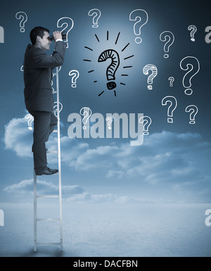 Businessman on a ladder next to question marks drawn Stock Photo