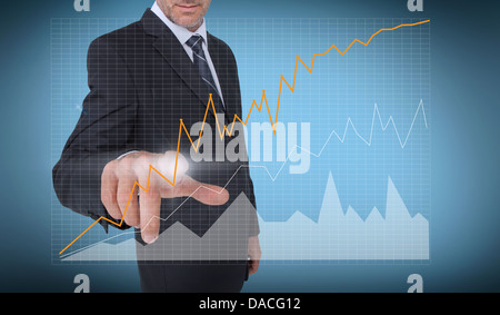 Businessman touching a curve of a chart Stock Photo
