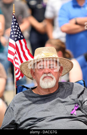 Prescott, Arizona, USA. 9th July, 2013. A man listens to a memorial service at Tim's Toyota Center. The 19 Granite Mountain Hotshots killed in the Yarnell fire were honored as a group Tuesday at a memorial in Prescott Valley. Firefighters from all over North America joined family members and community members to pay final respects. Credit:  Krista Kennell/ZUMAPRESS.com/Alamy Live News Stock Photo