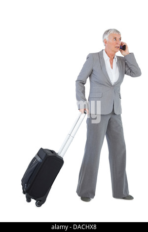 Businesswoman with her luggage and calling someone Stock Photo