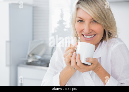 Happy woman having coffee in the morning Stock Photo