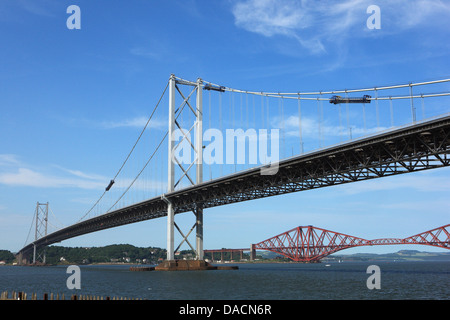 The Forth Rail Bridge seen below the Forth Road Bridge spanning the Firth of Forth from South to North Queensferry in Scotland Stock Photo