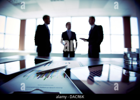 Colleagues meeting to discuss their future financial plans, only silhouettes being viewed Stock Photo