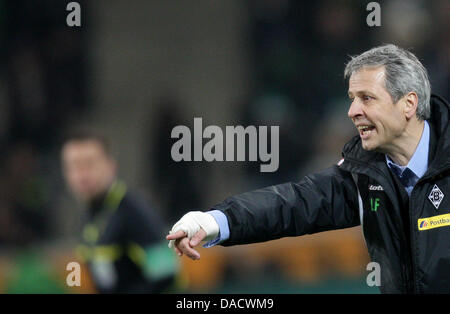 Gladbach's head coach Lucien Favre who has a broken arm gives instructions during the German Bundesliga soccer match between Borussia Moenchengladbach and FSV Mainz 05 at the Borussia Park in Moenchengladbach, Germany, 18 December 2011. Photo: Rolf Vennenbernd  (ATTENTION: EMBARGO CONDITIONS! The DFL permits the further  utilisation of the pictures in IPTV, mobile services and othe Stock Photo