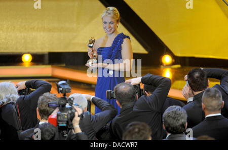 Biathlete Magdalena Neuner poses with her 'Athlete of the Year' Award at the 'Athlete of the Year' Gala at the Kurhaus in Baden-Baden, Germany, 18 December 2011. Photo: Franziska Kraufmann Stock Photo