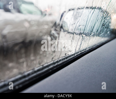 Rain on a car mirror and window Stock Photo