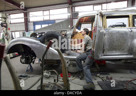 Automobile mechanic Peter Spillner works on the car body of a Mercedes-Benz 770 from 1941 in his workshop in Glienick, Germany, 23 November 2011. The company specialises in restoring historcial vehicles. Photo: Nestor Bachmann Stock Photo