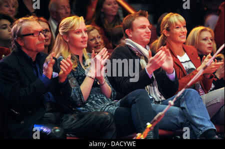 Kick Boxing World Champion Christine Theiss (R), her husband Hans and director and actor Franz Xaver Kroetz (L) and his girlfriend Juliane Grund (2-L) attend the premiere of the winter programme of Circus Krone in Munich, Germany, 25 December 2011. The winter shows are running until 15 April 2012. Photo: Tobias Hase Stock Photo