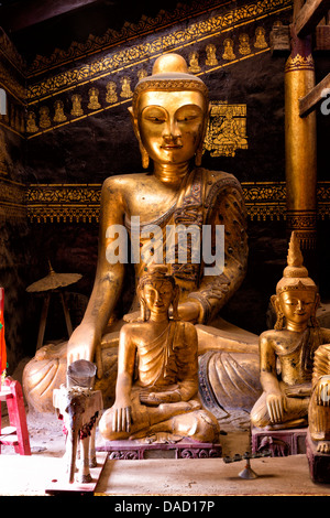 Ancient gilded wooden Buddhas inside Wat In, Kengtung (Kyaingtong), Shan State, Myanmar (Burma), Asia Stock Photo