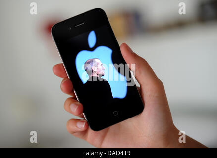 (dpa file) - A file picture dated 25 August 2011 shows a photo of co-founder and head of Apple, Steve Jobs, featured on an Apple iPhone 4 in Hanover, Germany. Co-founder and long-standing head of Apple died on 05 October 2011 at the age of 56 in California. Jobs battled pancreatic cancer for many years. Photo: Julian Stratenschulte Stock Photo