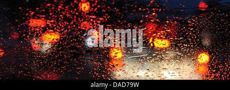 Cars a stuck in a traffic jam at a highway near Freiburg and the rear lights are reflected in the raindrops of a windshield, Germany, 10 October 2011. Many people drove by car on 10 October 2011, because of a warning strike of bus- and tram drivers in Baden-Wuerttemberg. Photo: Patrick Seeger Stock Photo
