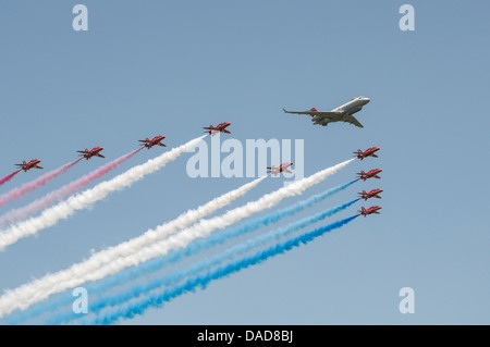 The British Royal Air Force Red Arrows Aerobatic Display Team make a formation flypast at Waddington with a Bombardier BD-700 Stock Photo