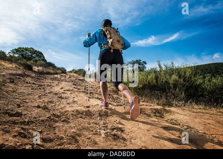 Young woman hiking, rear view Stock Photo