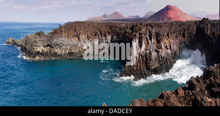 rocky coast and volcanic cone, Canary Islands, Lanzarote Stock Photo