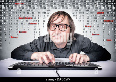 Funny hacker in action on his keyboard Stock Photo