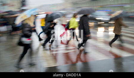 Passers-by cross a pedestrian crossing in St. Petersburg, Russia, 03 October 2011. Photo: Arno Burgi Stock Photo