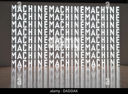 A 3D video installation with the writing 'Machine' is seen during the video press preview of the exhibition 'Kraftwek 3-D Video Installation' at the Kunstbau of the Municipal Gallery in Lenbachhaus in Munich, Germany, 13 October 2011. The design of the exhibition is meant to make the minimalistic sounds and images of Kraftwerk tangible to a broad public. The video installation can  Stock Photo